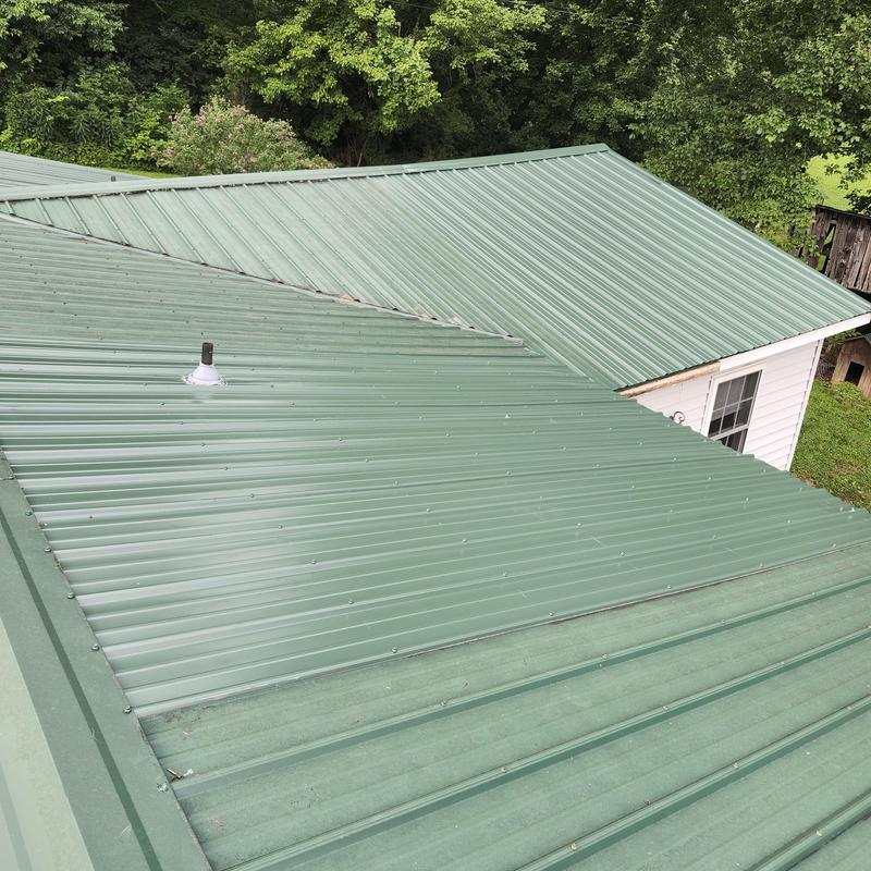 Metal roof panels on residential home after damage