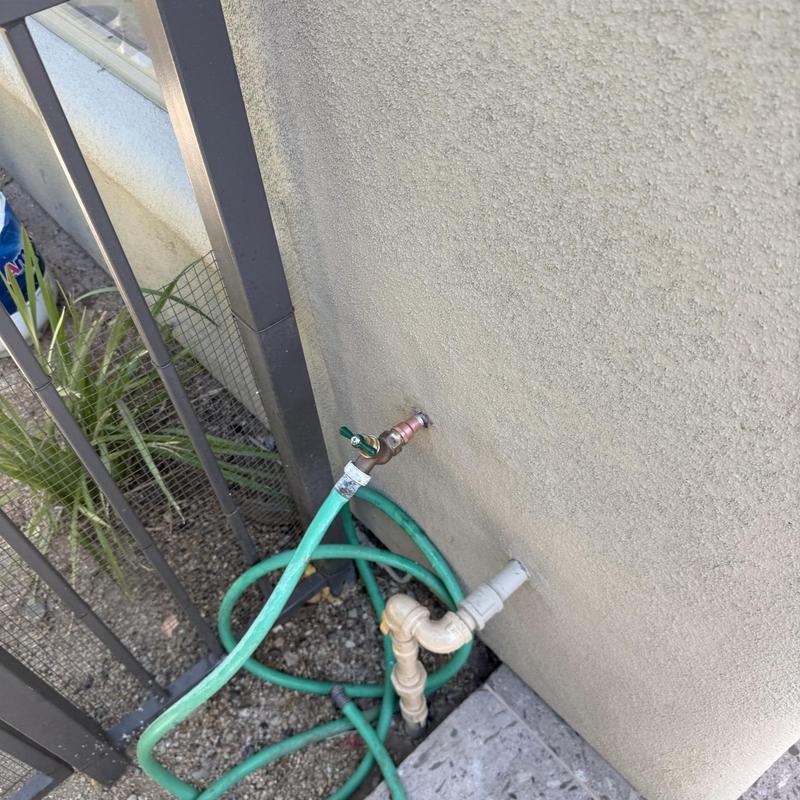 Outdoor hose bib with basket strainer and hose attached