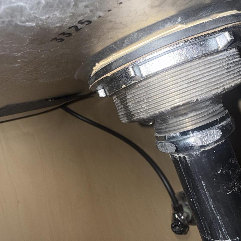 Basket strainer connection under sink with plumbing pipe