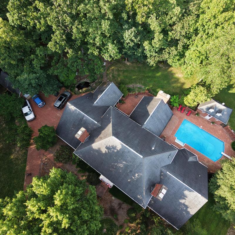 Residential asphalt shingle roof replacement with pool view