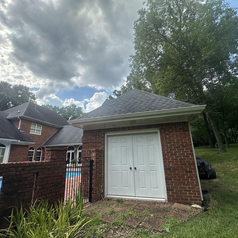 Asphalt shingle roof on pool house with white doors