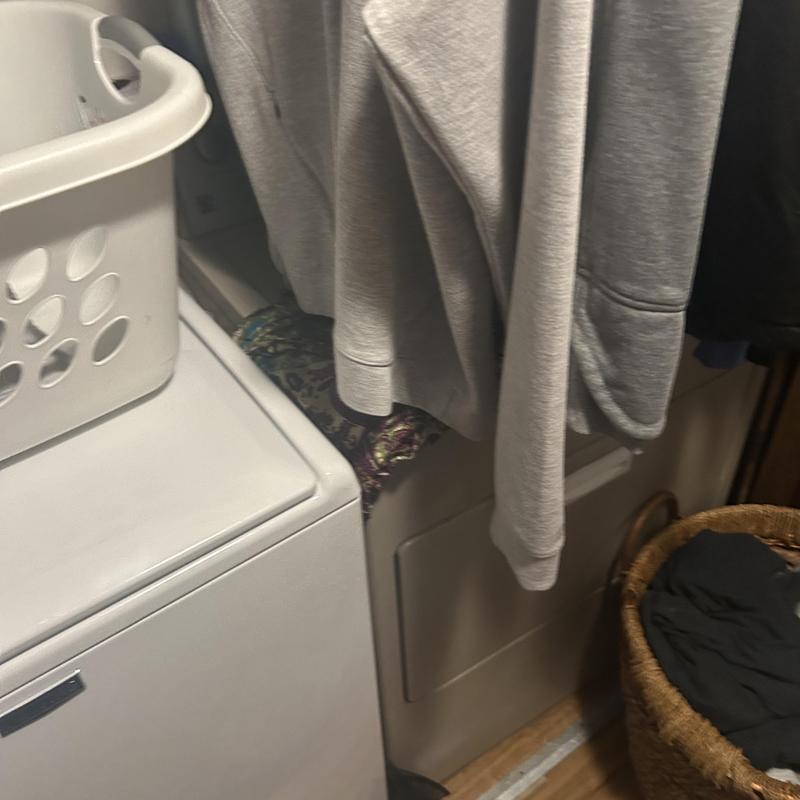 Dryer relocation area with laundry basket and clothes hanging Dryer relocation area with laundry basket and clothes hanging
