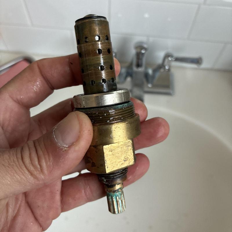 Shower faucet cartridge with corrosion before cleaning