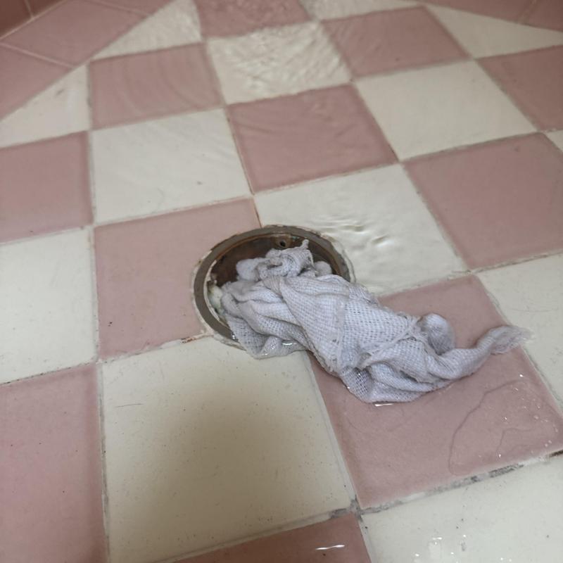 Shower drain clogged with cloth during cleaning process