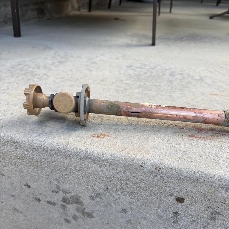 Copper hose bibb with visible corrosion and damage. Copper hose bibb with visible corrosion and damage.