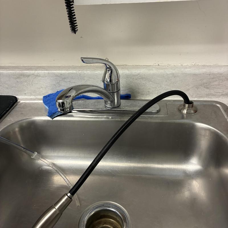 Utility sink Moen faucet with flexible spout installed