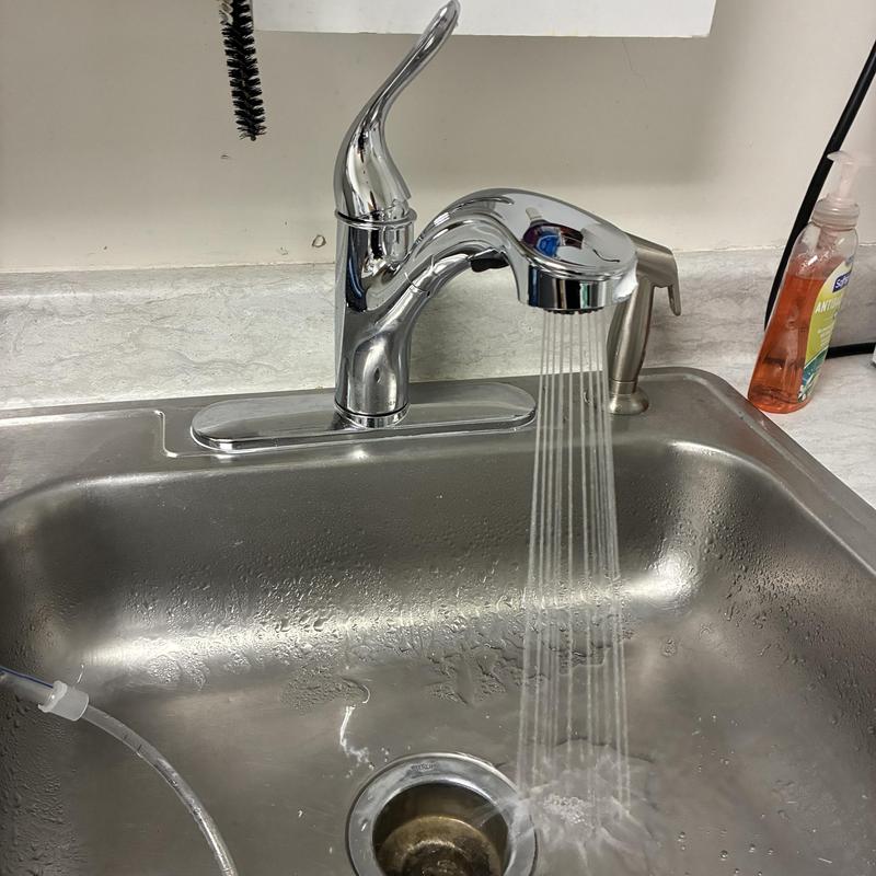 Utility sink Moen faucet with water running