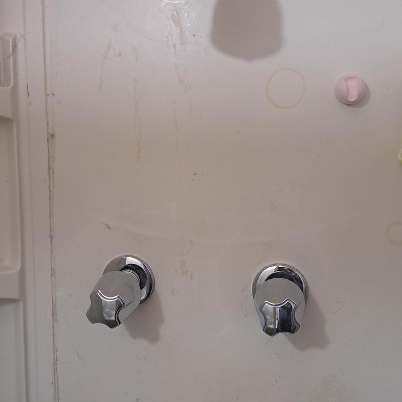 Two-handle shower valve with chrome knobs on wall Two-handle shower valve with chrome knobs on wall