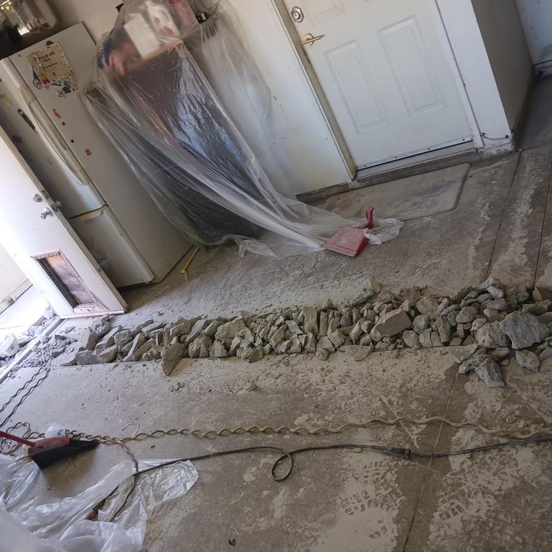 Concrete floor trench for plumbing line installation