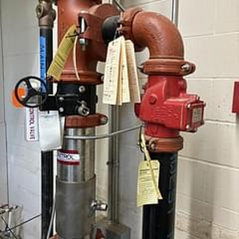 Backflow prevention devices with test tags attached Backflow prevention devices with test tags attached