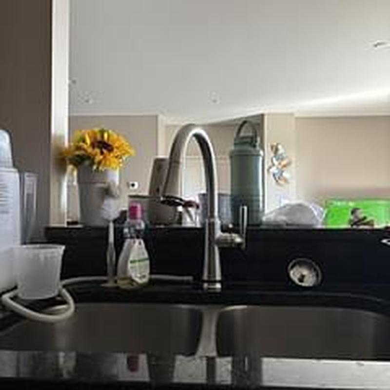 Delta Coranto pull-out kitchen faucet on black countertop