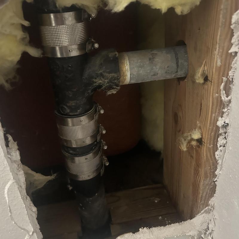 Kitchen sink drain pipe with repaired leak access hole Kitchen sink drain pipe with repaired leak access hole