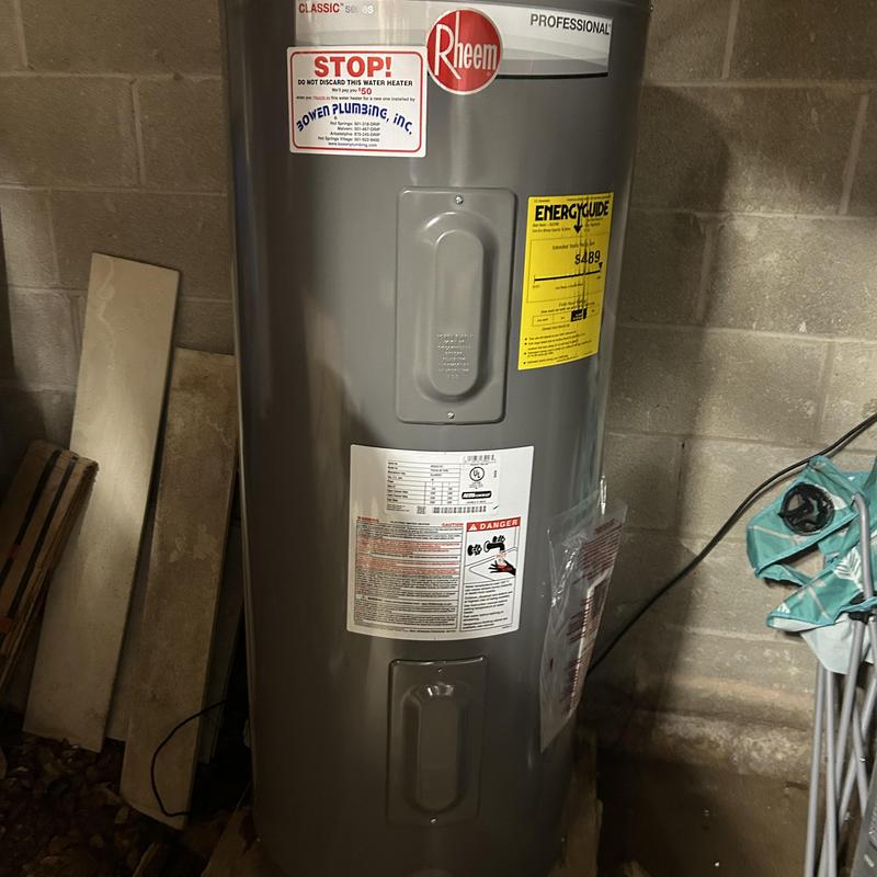 Electric water heater installed in basement wall Electric water heater installed in basement wall