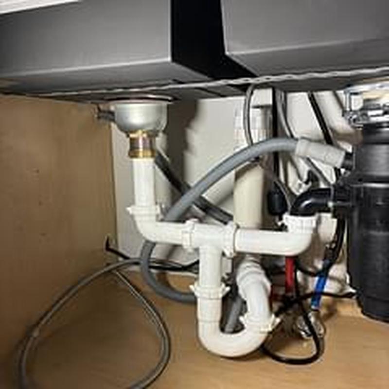 Basket strainer and drain piping under kitchen sink