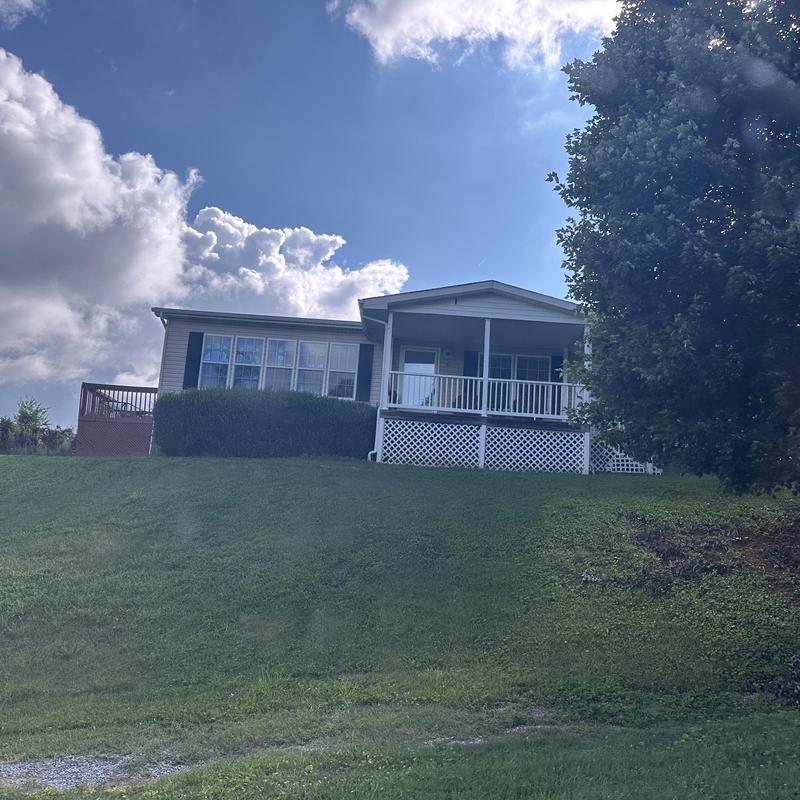 Residential roof with porch and grassy yard