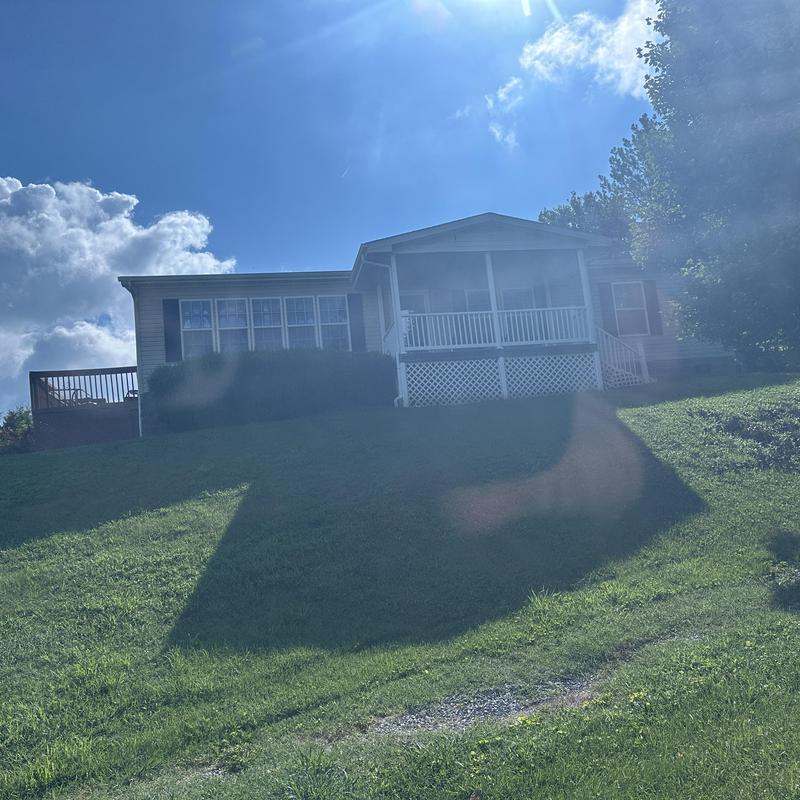 Residential roof on house with front porch in sunlight