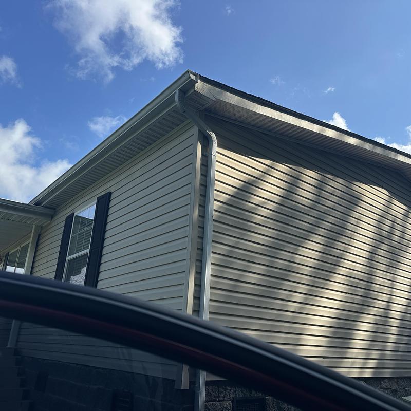 Residential roof edge and gutter installation on house