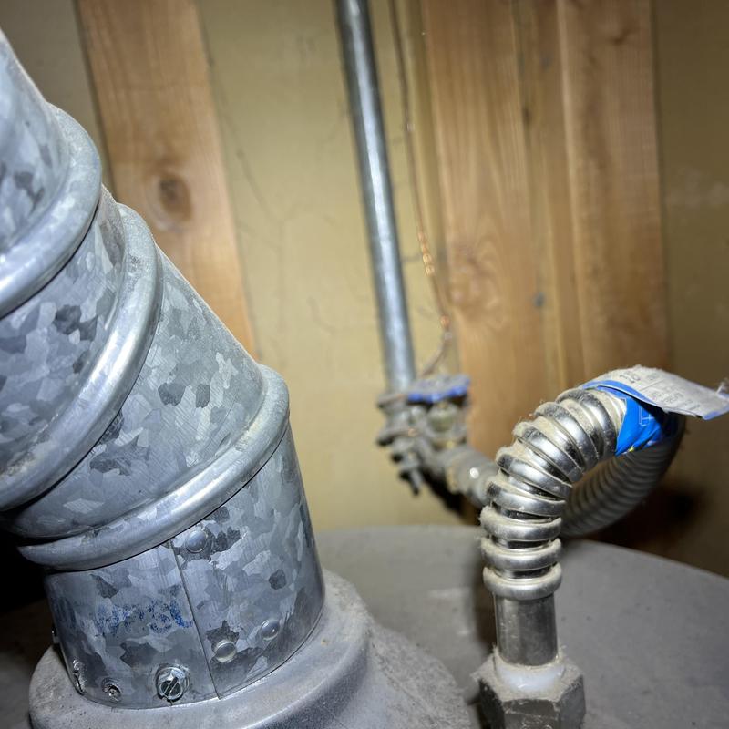 Flexible gas line connection to water heater vent pipe Flexible gas line connection to water heater vent pipe