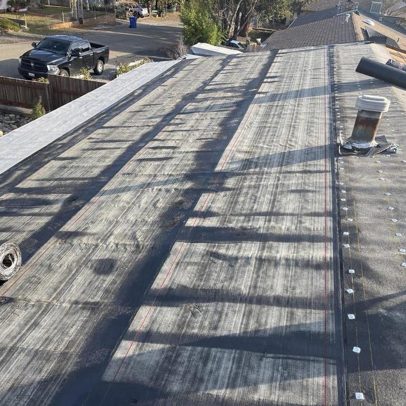 Torch down roofing installation on low slope roof