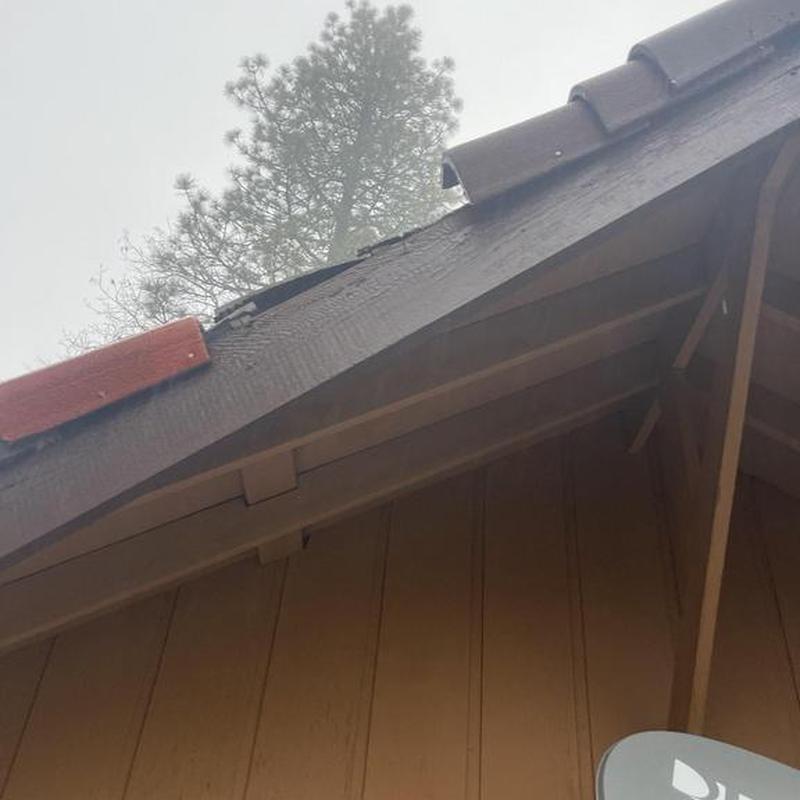 Tile roof ridge with wood fascia and satellite dish