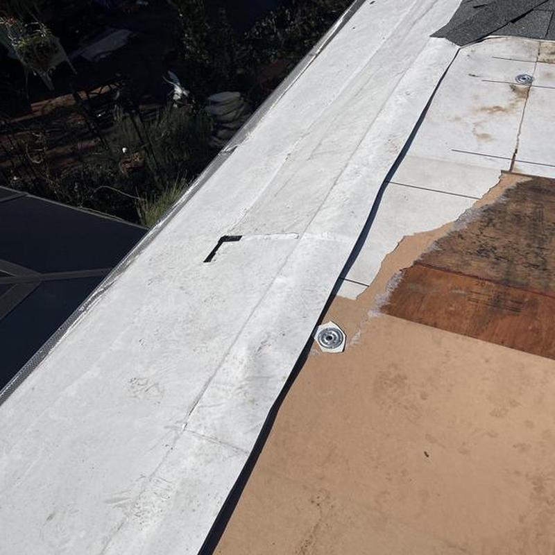 Torch down roofing installation on flat commercial roof