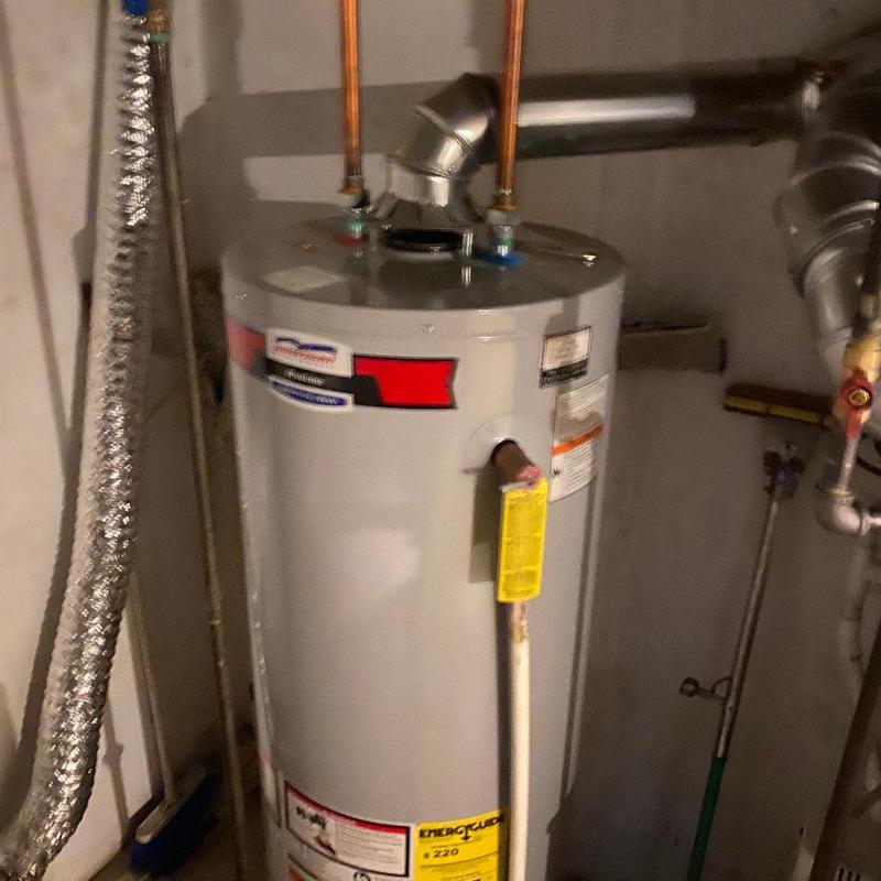 Water heater with piping and vent installation in basement Water heater with piping and vent installation in basement