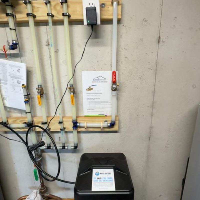 Sump pump system with installed spigot and piping