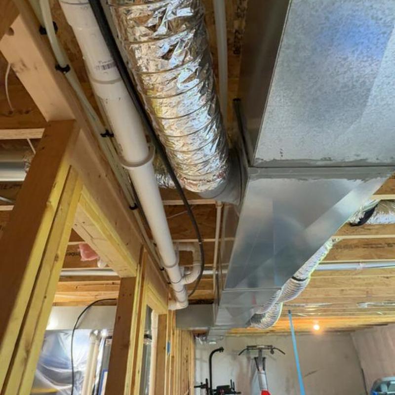 Sump pump and spigot plumbing installation in basement