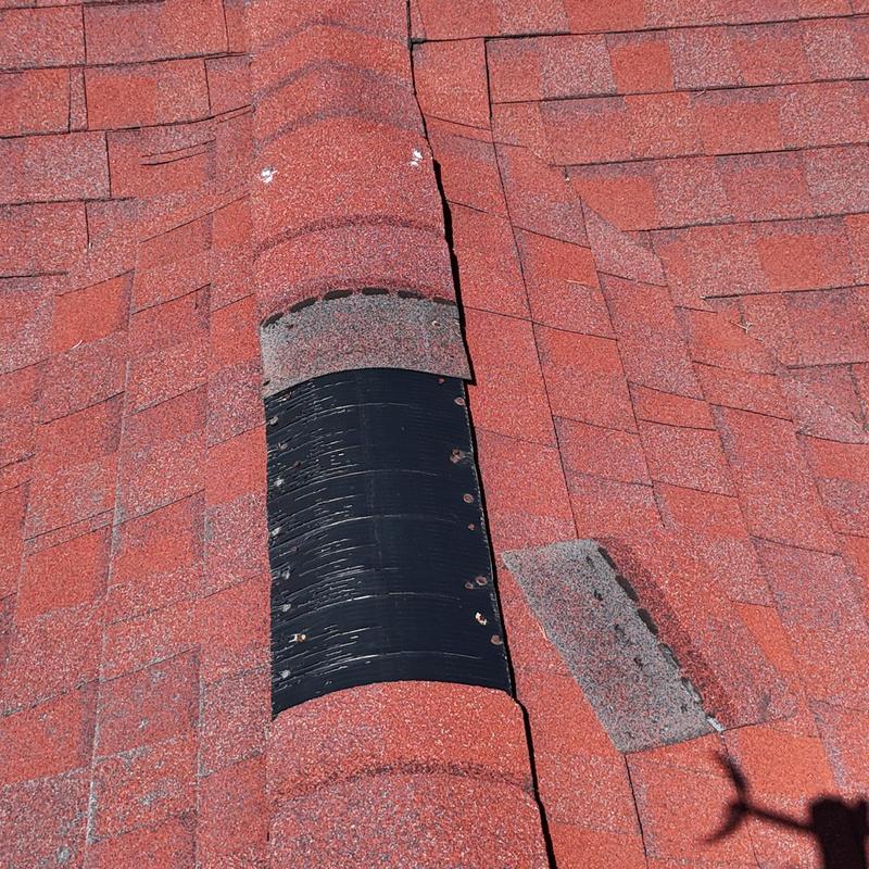 Asphalt shingle roof with ridge vent and damaged shingles