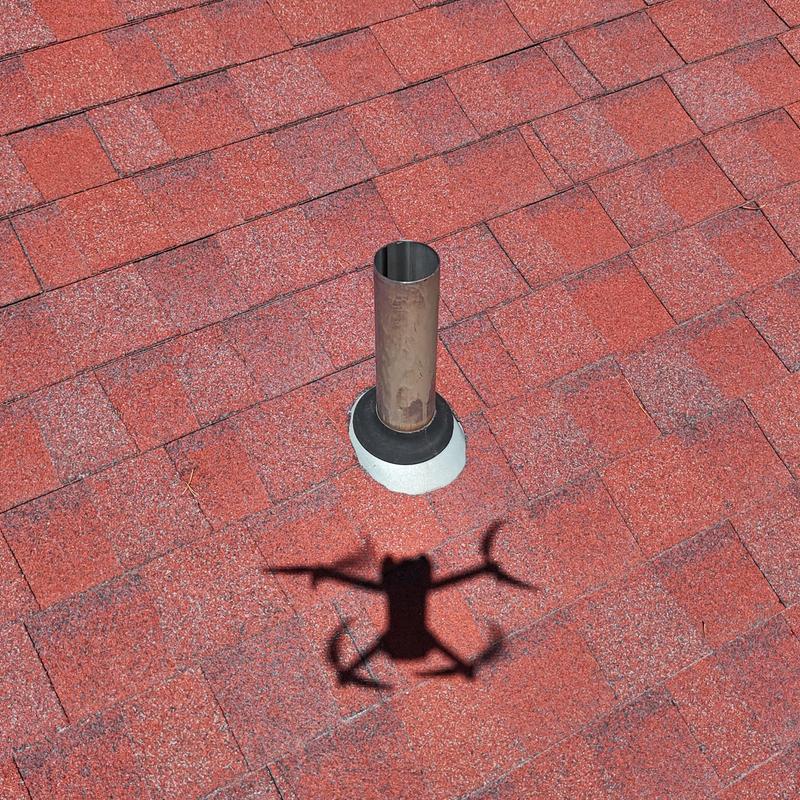 Asphalt shingle roof with metal vent pipe and flashing