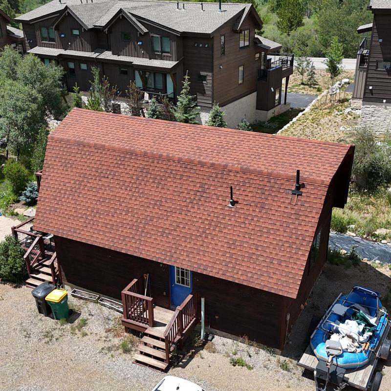 Laminate asphalt shingle roof with vents on cabin