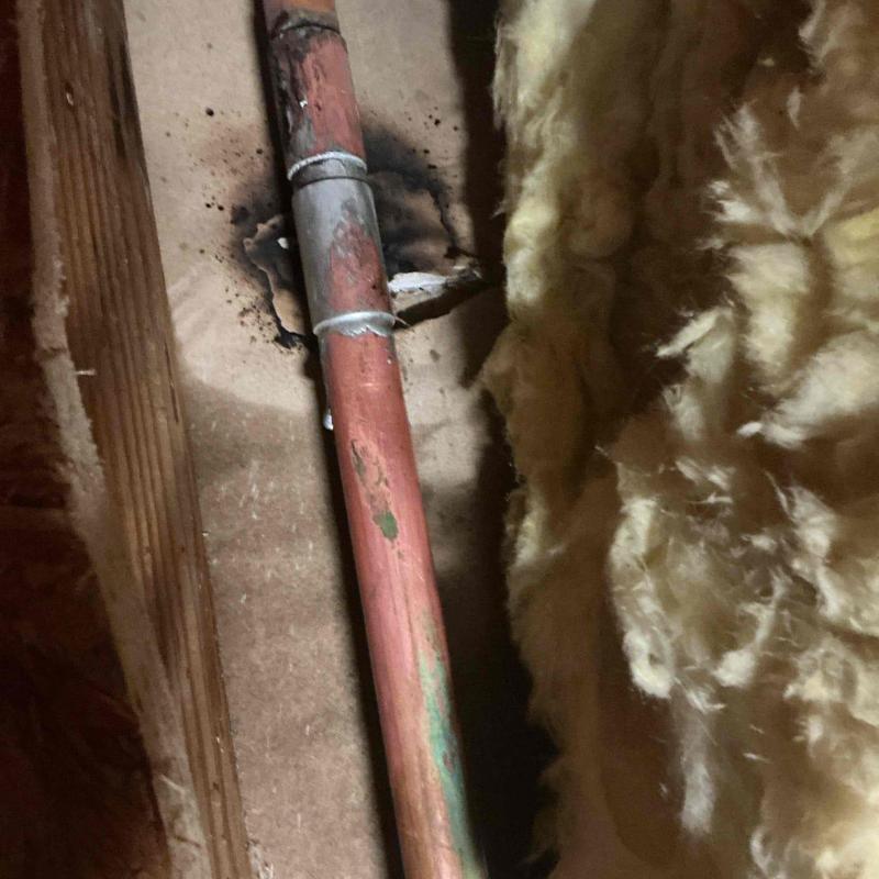 Copper water pipe with slip coupling in attic leak repair
