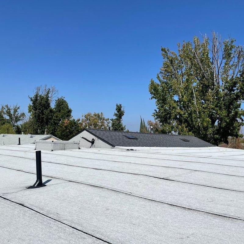 Flat roof membrane inspection with vent pipe in view Flat roof membrane inspection with vent pipe in view