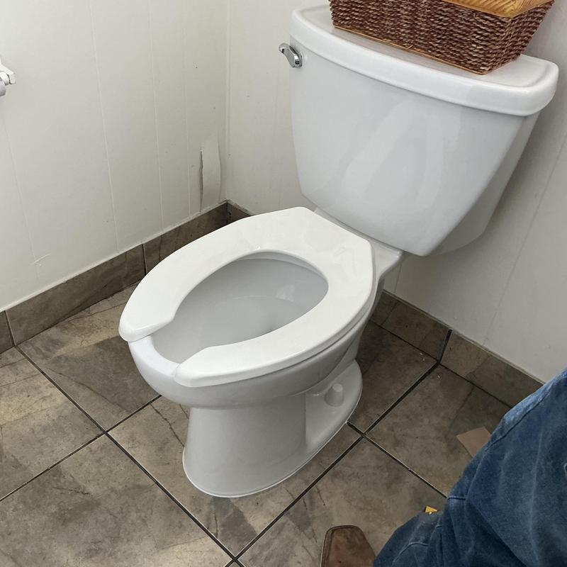 Toilet bowl and tank installation with basket on top