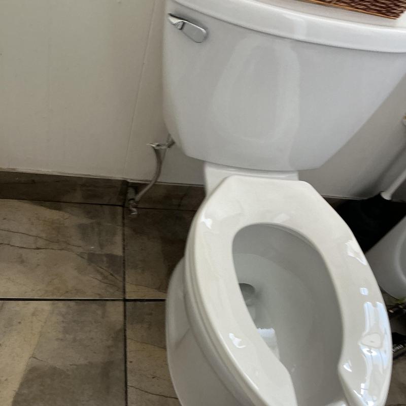 Toilet installation in tiled bathroom corner