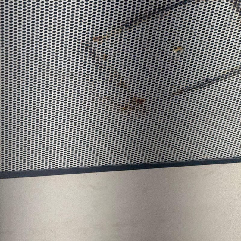 Perforated metal ceiling with rust stains