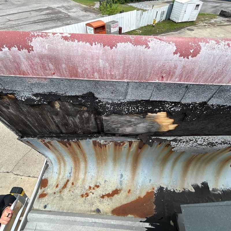 Metal roof edge corrosion and wood water damage inspection