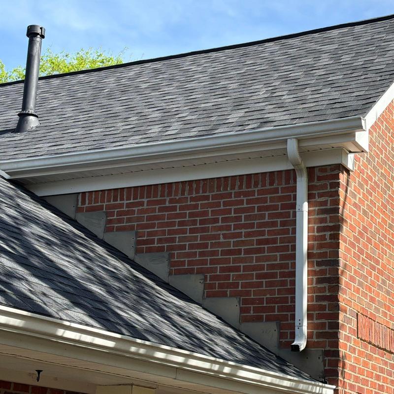 Asphalt shingle roof with chimney pipe and gutter system