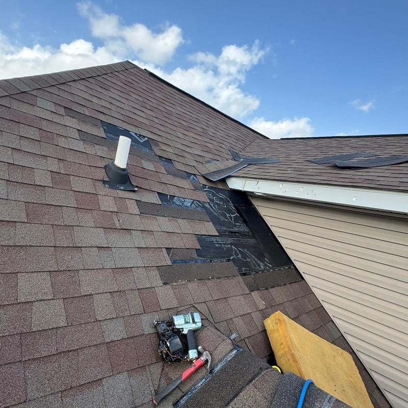 Asphalt shingles roof with missing and damaged panels