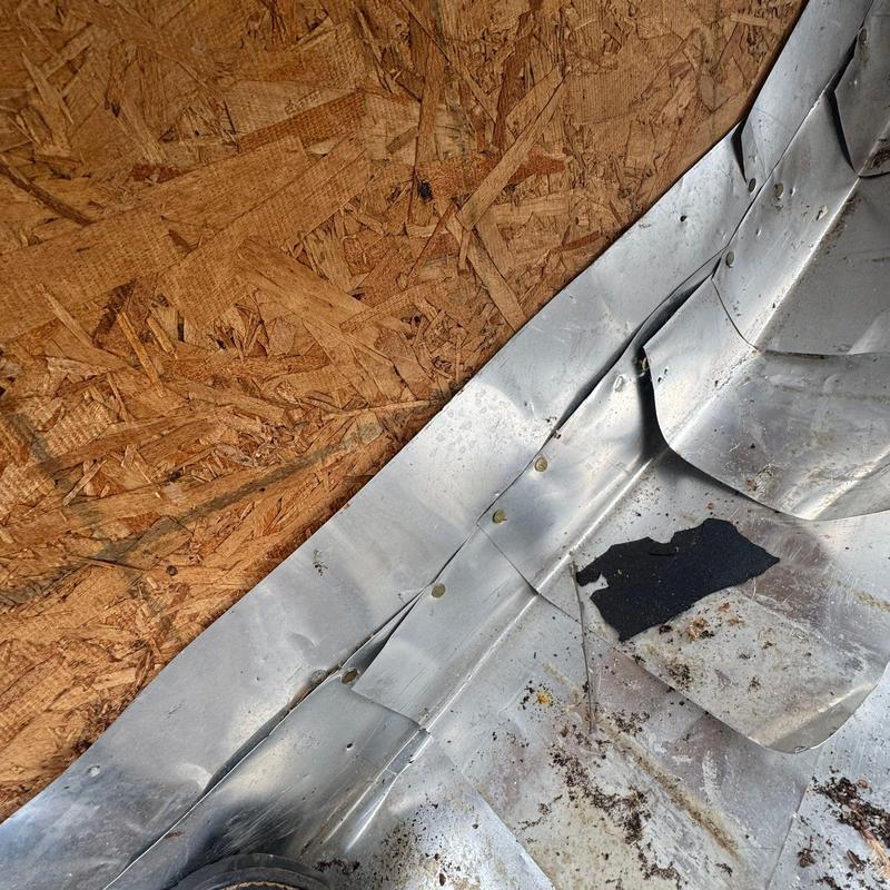 Roof flashing with dents and damage from hail impact