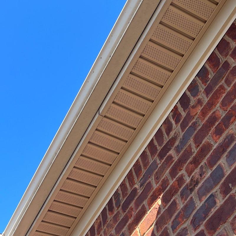 Soffit and fascia with gutter attached on brick wall