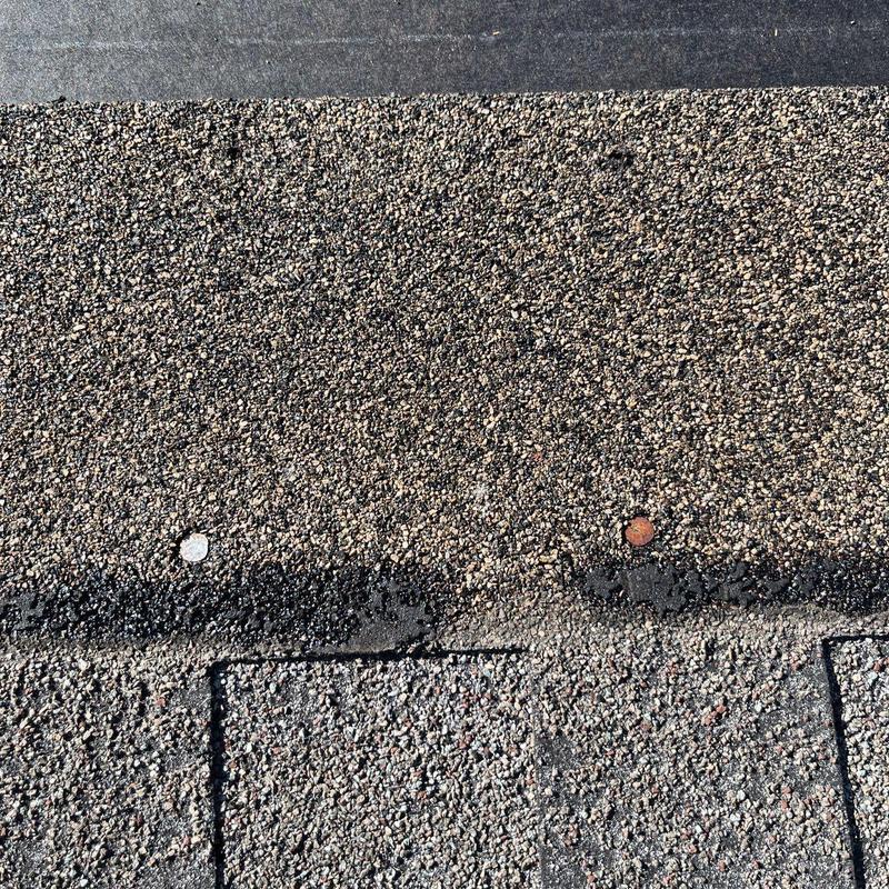 Asphalt shingles with hail damage and nail spots
