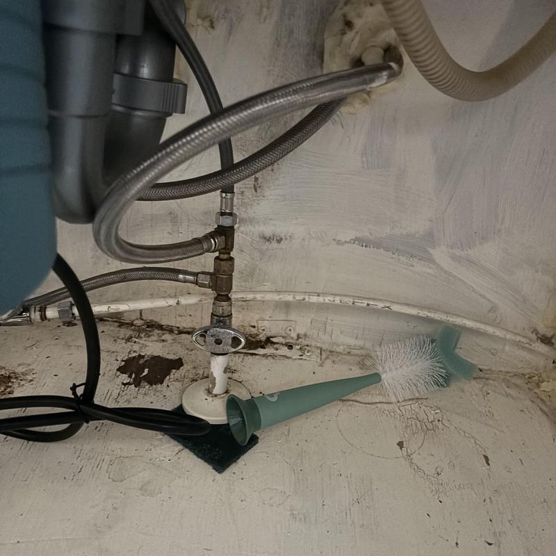 Plumbing supply valve with braided hoses under sink Plumbing supply valve with braided hoses under sink