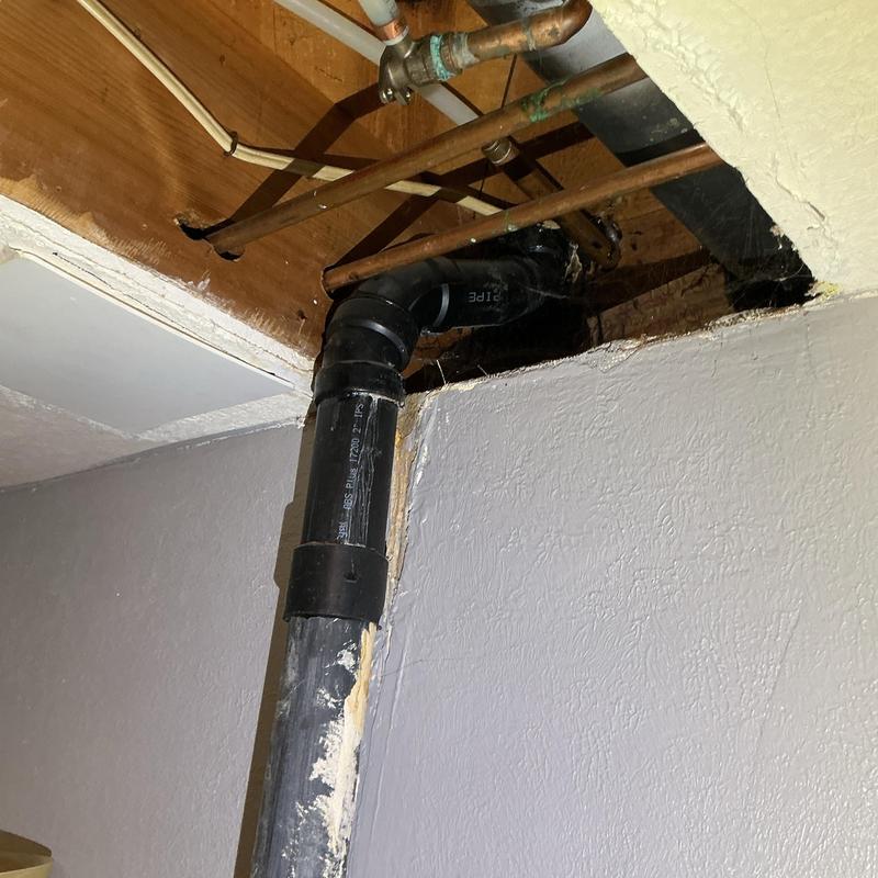 PVC drain pipe under ceiling with copper water lines above PVC drain pipe under ceiling with copper water lines above