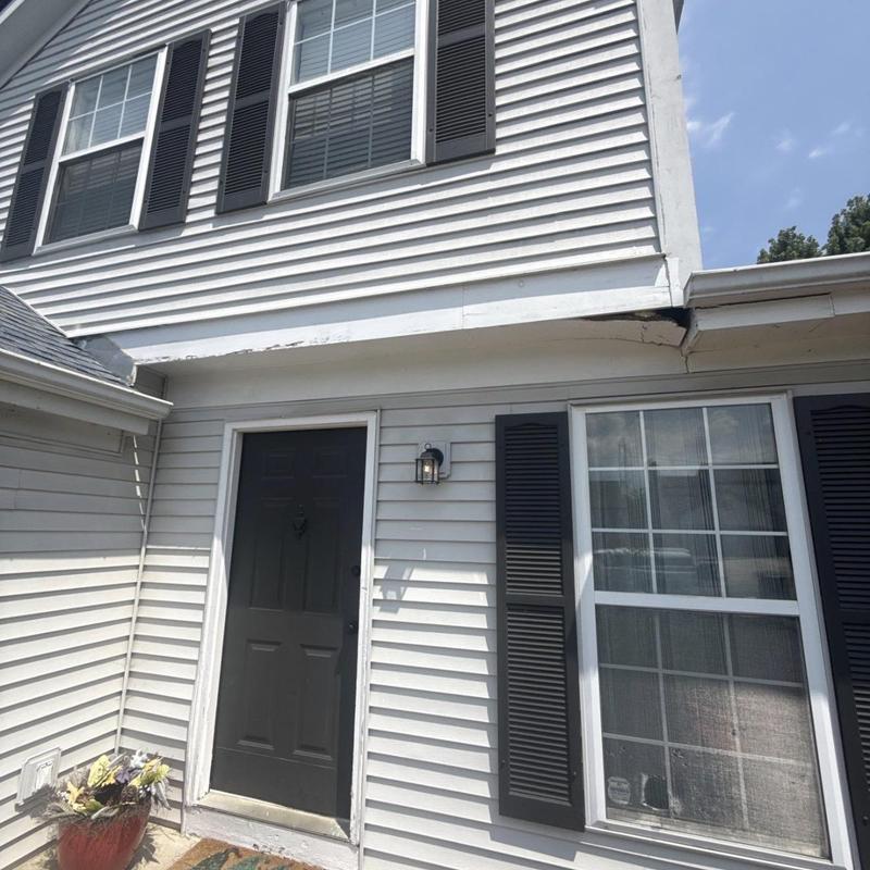 Vinyl siding damage near entry door and window trim Vinyl siding damage near entry door and window trim