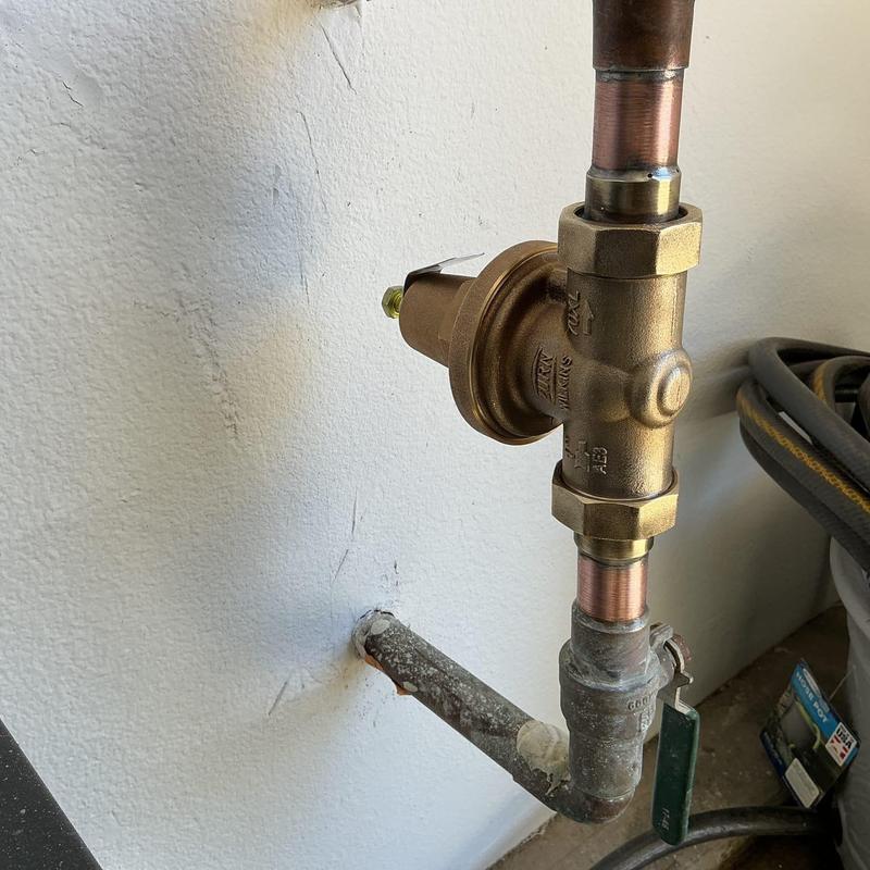 Pressure regulator with new seals installed on copper pipe