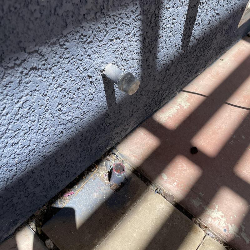 Gas line stub capped outside on concrete patio