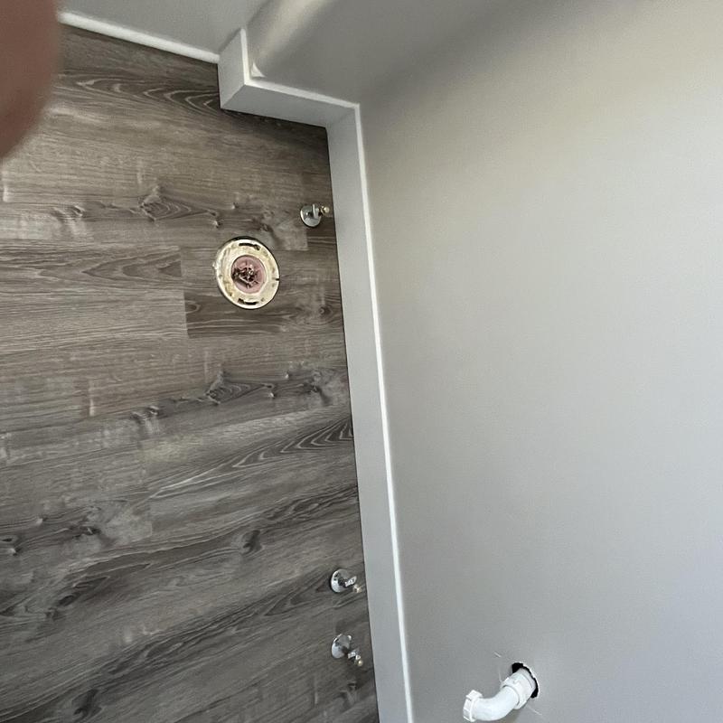 Toilet flange and water supply rough-in on wood floor Toilet flange and water supply rough-in on wood floor