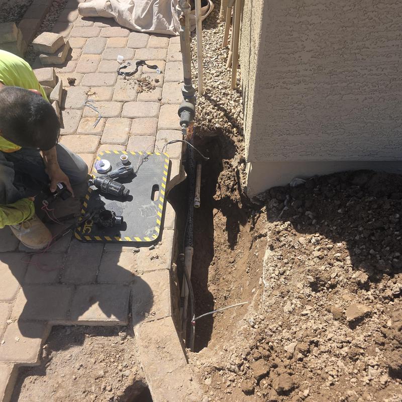 Water service line replacement beside home foundation trench