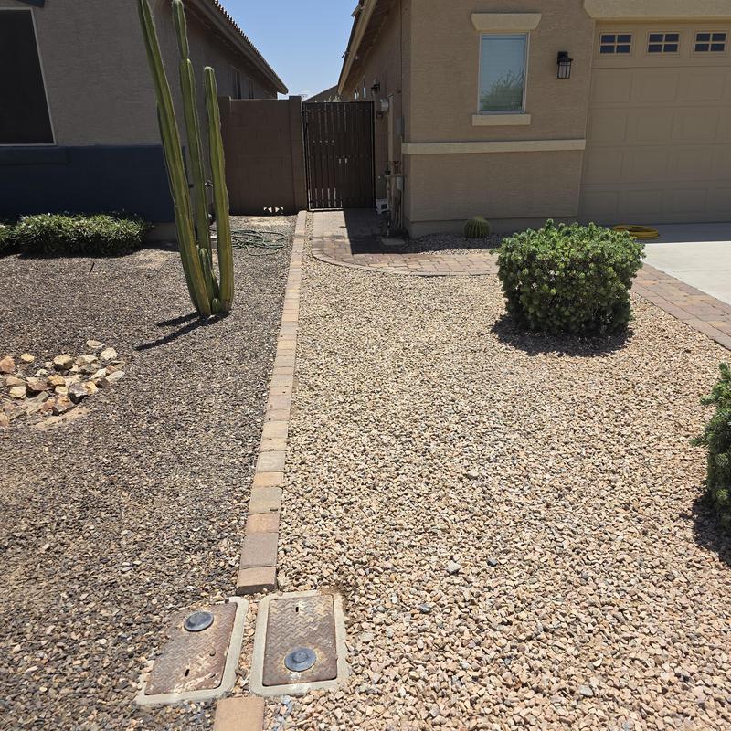 Water meter boxes in front yard gravel landscape